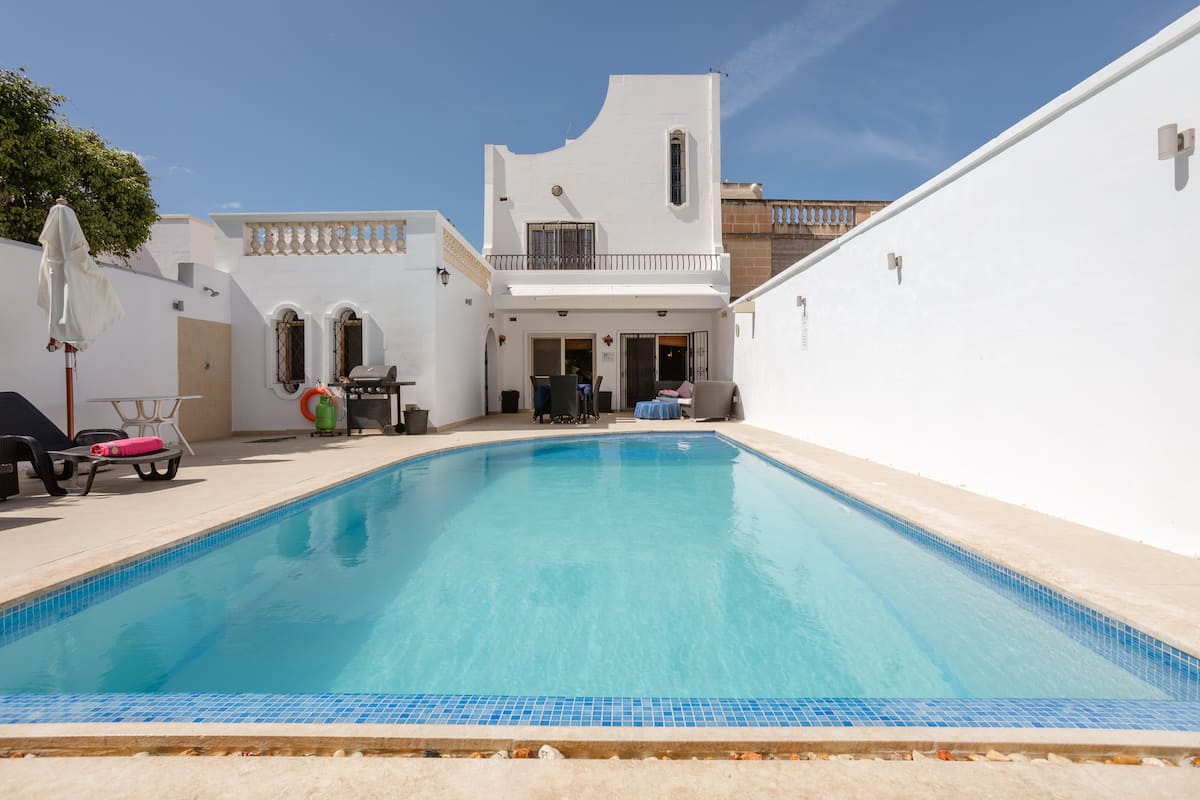 The big private pool and white courtyard at the Swieqi villa, Malta